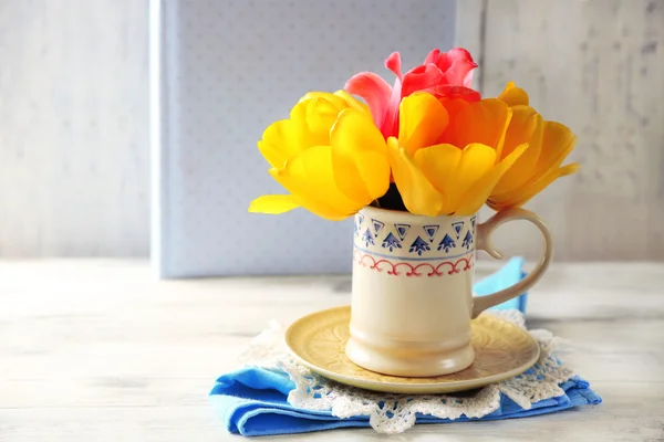 Spring bouquet in colorful mug — Stock Photo, Image