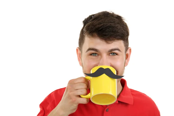 Portrait of man drinking from cup with cutout mustache, isolated on white — Stock Photo, Image