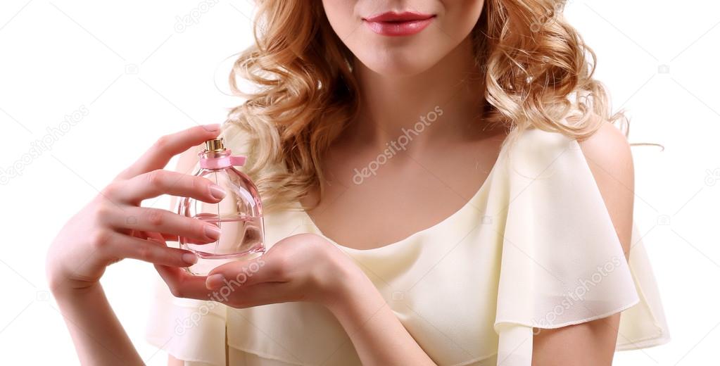 Beautiful young woman with perfume bottle isolate on white