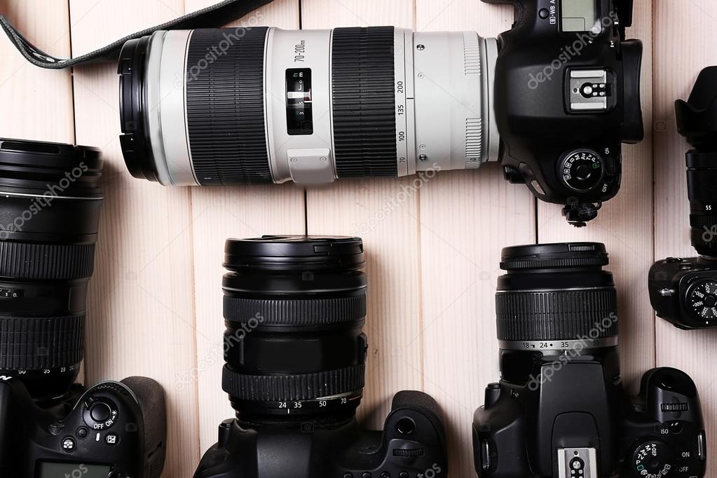 modern cameras on wooden table