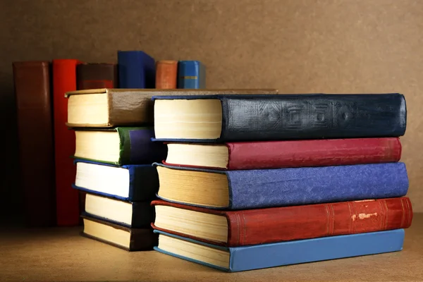 Old books on shelf, close-up, on wooden background — Stock Photo, Image
