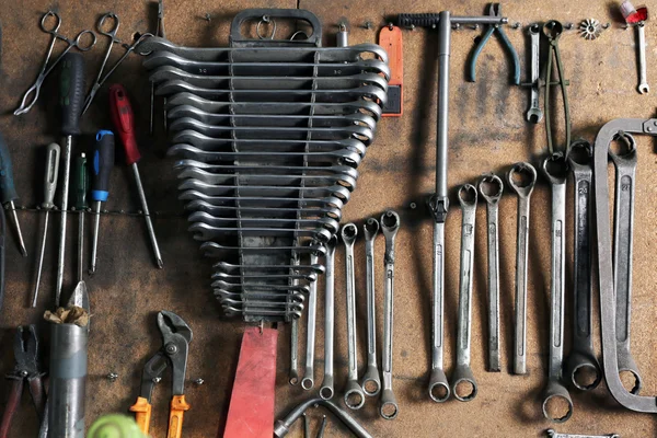 Different tools on workplace in garage — Stock Photo, Image