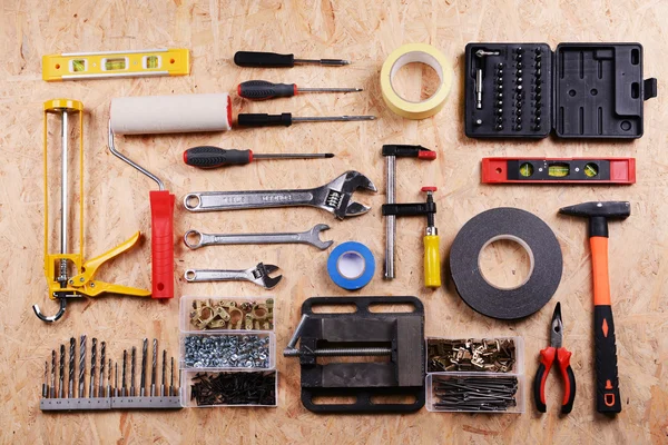 Set of tools on plywood, top view — Stock Photo, Image