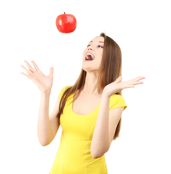 Healthy young woman throwing up red apple isolated on white — 스톡 사진