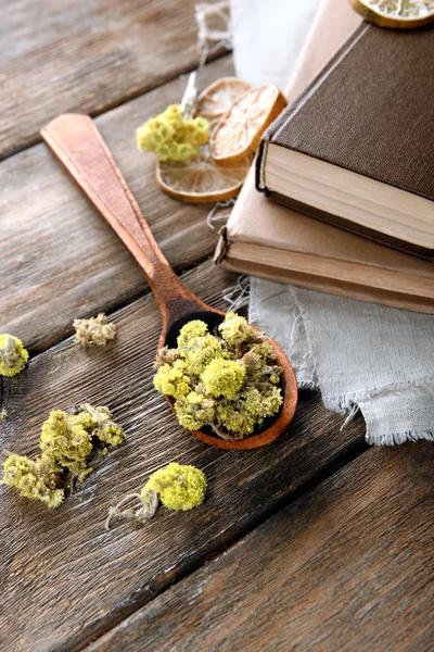 Old books with dry flowers and lemon on table close up — Stock Photo, Image