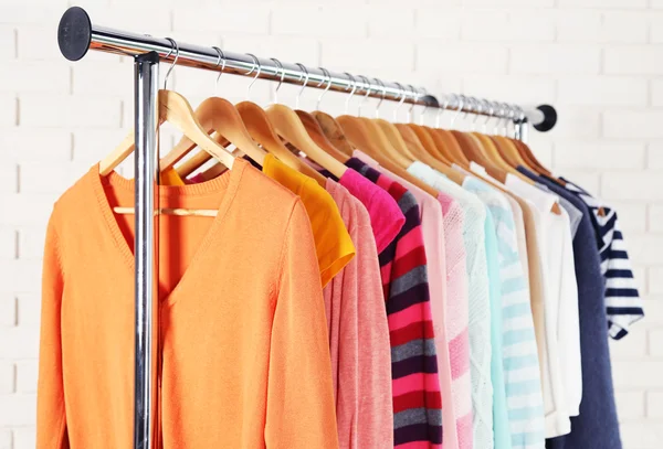 Different clothes on hangers close up — Stock Photo, Image