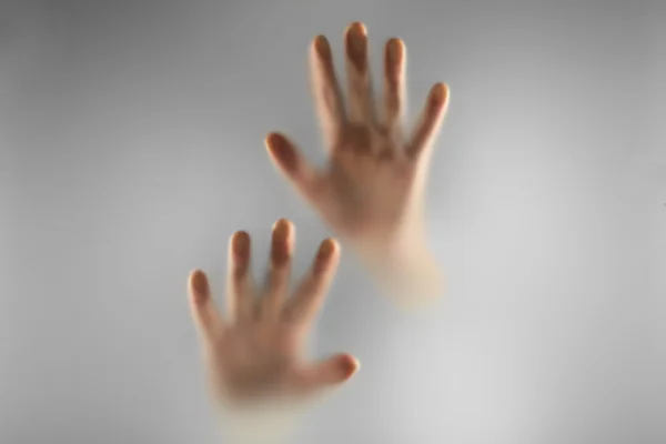 Hands silhouettes behind glass foreground — Stock Photo, Image