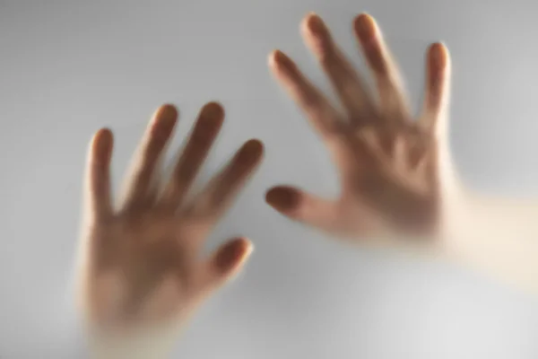 Hands silhouettes behind glass foreground — Stock Photo, Image