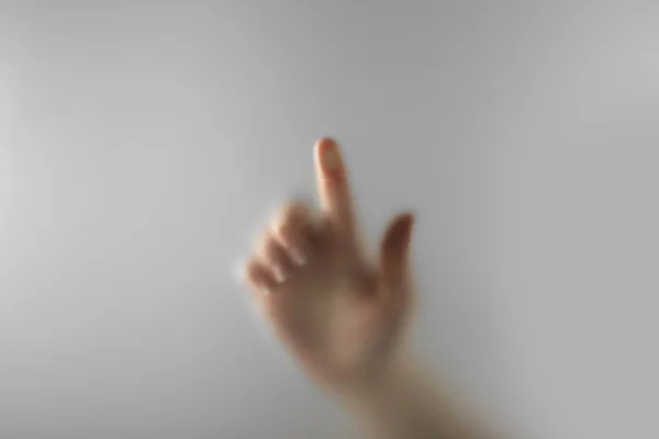 Hand silhouettes behind glass foreground — Stock Photo, Image