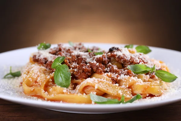 Pasta Bolognese with parmesan and basil on dark background — Stock Photo, Image