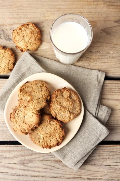 Hausgemachte Kekse und ein Glas Milch auf dem Tisch aus nächster Nähe — Stockfoto