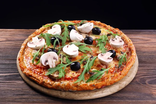 Tasty pizza with vegetables and arugula on black background — Stock Photo, Image