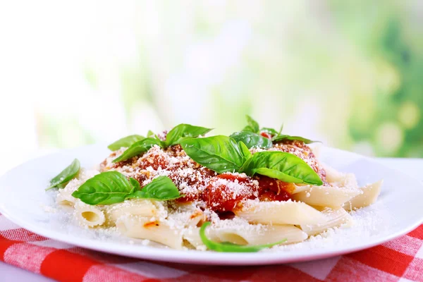 Pasta with tomato sauce on bright background — Stock Photo, Image