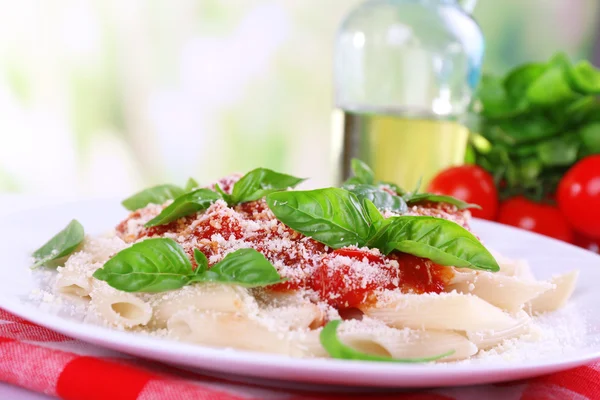 Pasta with tomato sauce on bright background — Stock Photo, Image