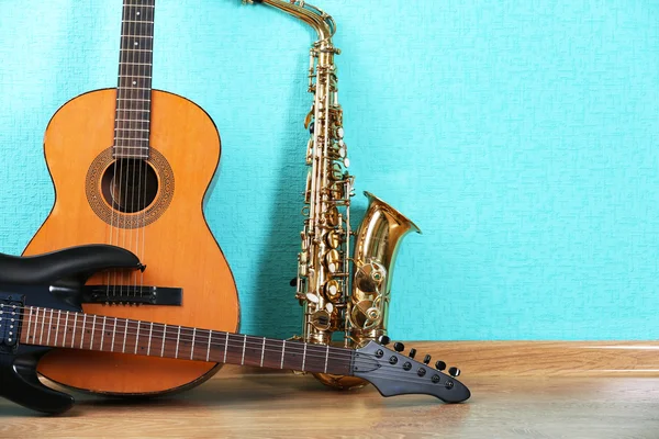 Musical instruments on turquoise wallpaper background — Stock Photo, Image