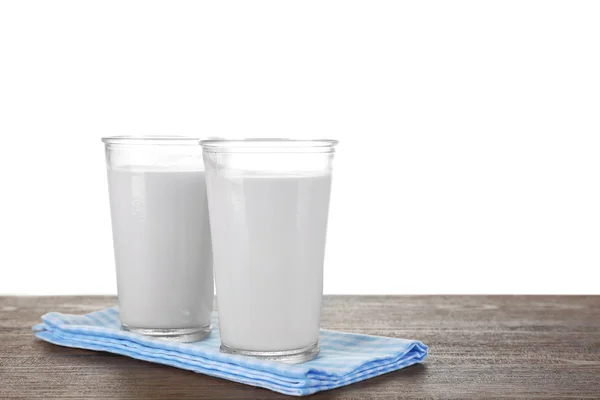 Glazen melk op houten tafel, op witte achtergrond — Stockfoto