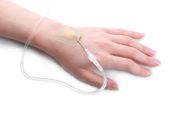 Woman hand with dropper needle on bed close-up — Stock Photo, Image