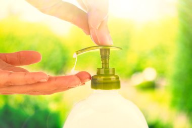 Doğa arka plan üzerinde sıvı sabun kullanarak eller
