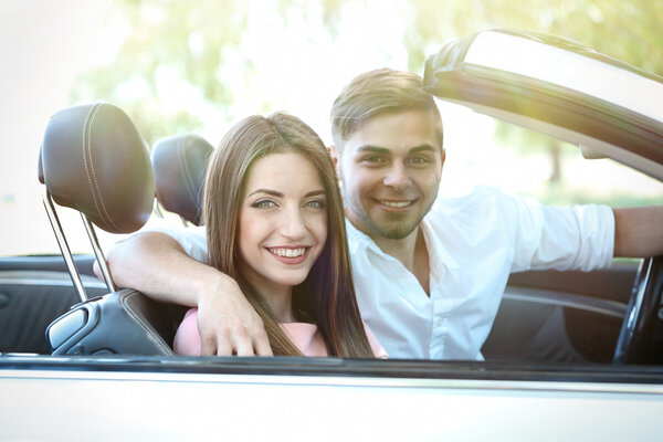 Young couple in cabriolet, outdoors