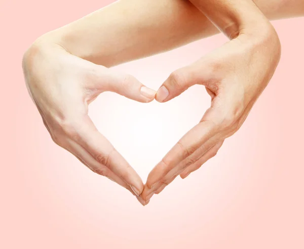 Hands in shape of heart on light background — Stock Photo, Image