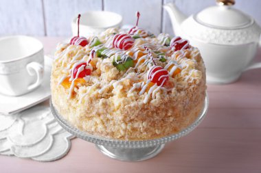 Butter cake with cherries on stand and table setting