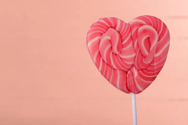 Bright lollipop in shape of heart — Stock Photo, Image