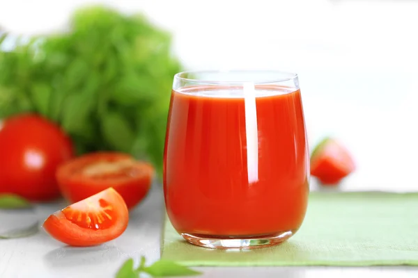 Jugo de tomate y tomates frescos en primer plano de mesa de madera — Foto de Stock