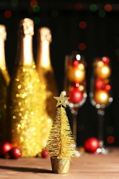 Decorative champagne bottles with Christmas balls on dark background — Stock Photo, Image