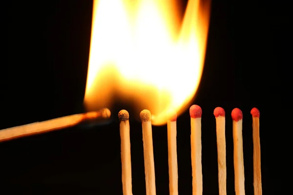 Burning matches on black background — Stock Photo, Image