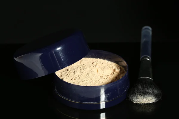 Jar with loose cosmetic powder and makeup brush, isolated on black — Stock Photo, Image