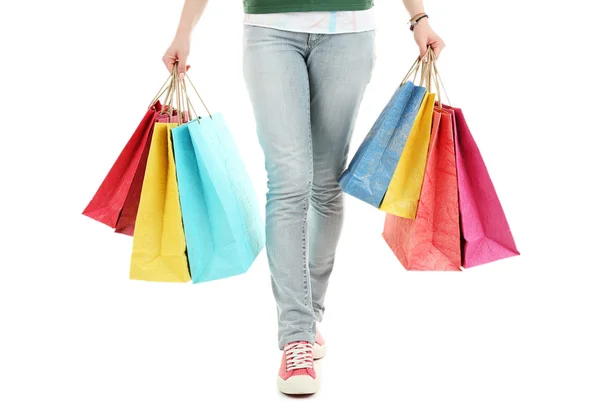 Bolsas de papel de compras coloridas en manos femeninas aisladas en blanco —  Fotos de Stock