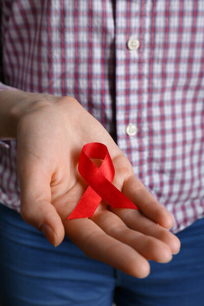 Female hand with color ribbon, closeup