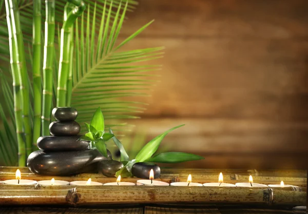 Spa stones, candles on wooden background — Φωτογραφία Αρχείου