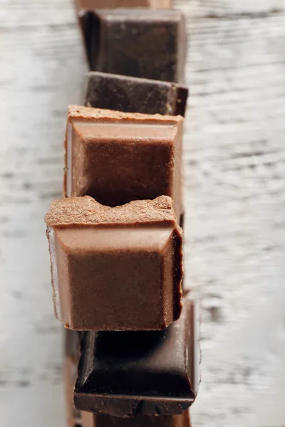 Squared chocolate on wooden table, top view — Stock Photo, Image