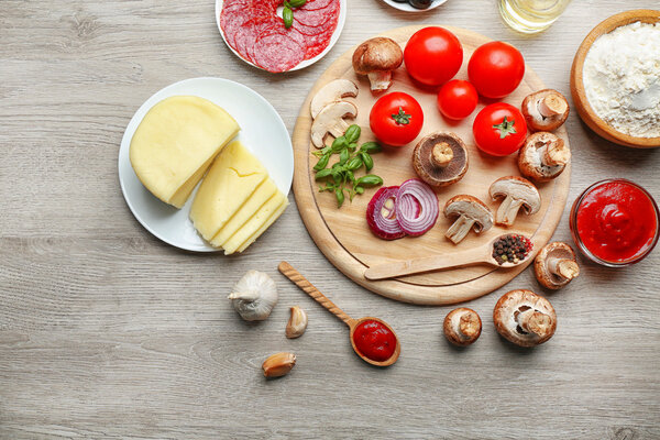 Ingredients for cooking pizza on wooden table, top view