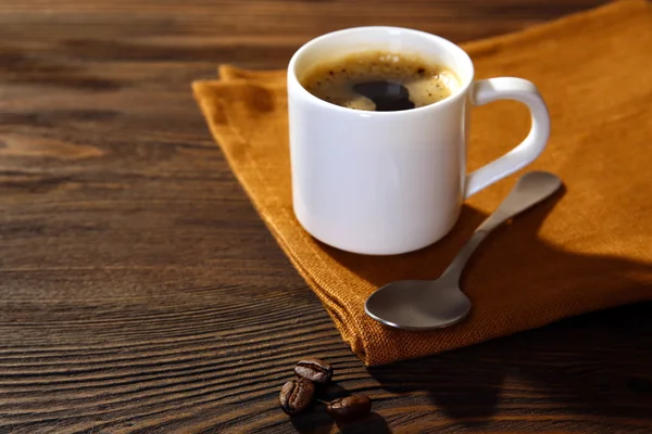 Cup of coffee on napkin on table close up — Stock Photo, Image