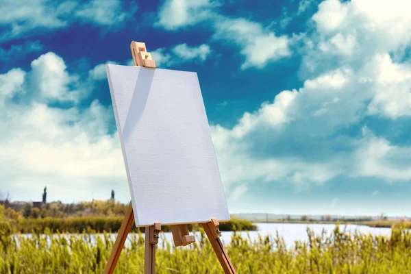 Easel with canvas outdoors — Stock Photo, Image