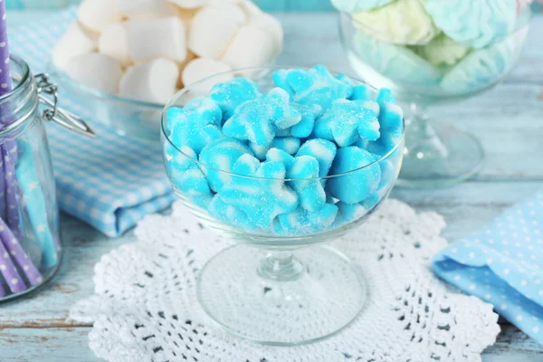 Sweet candies in glassware on wooden table, closeup — Stock Photo, Image