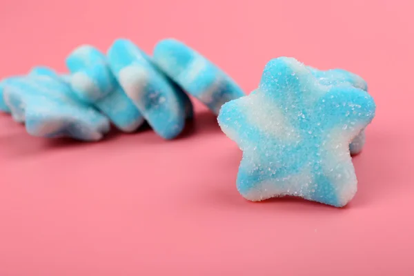 Blue candies on pink background — Zdjęcie stockowe