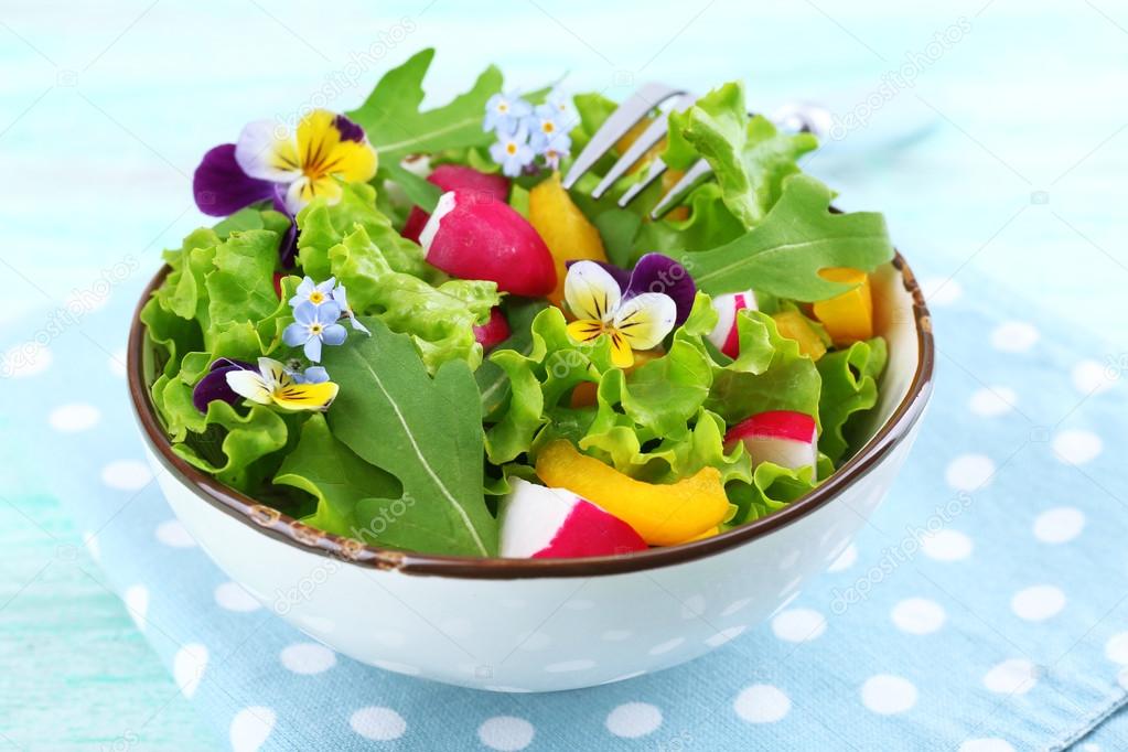 Light organic salad with flowers, close up