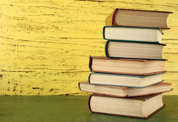 Stack of books on wooden background — Stock Photo, Image