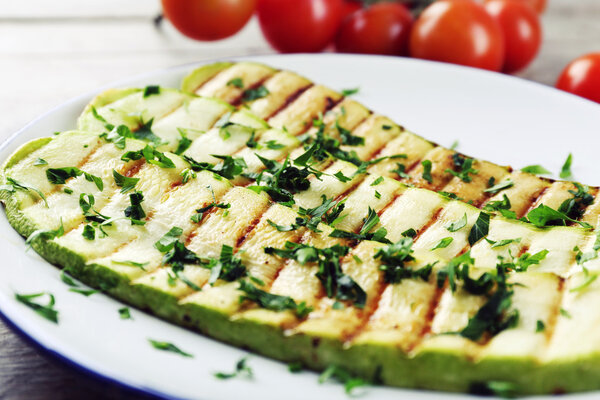 Grilled vegetable mallow in white plate on wooden table, closeup