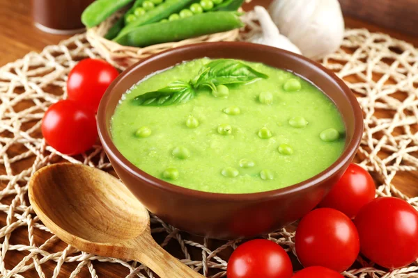 Tasty peas soup and vegetables on table close up — Stock Photo, Image