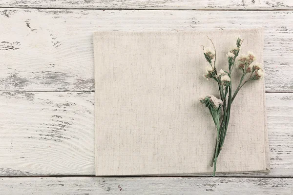 Beautiful dry flowers on napkin — Stock Photo, Image
