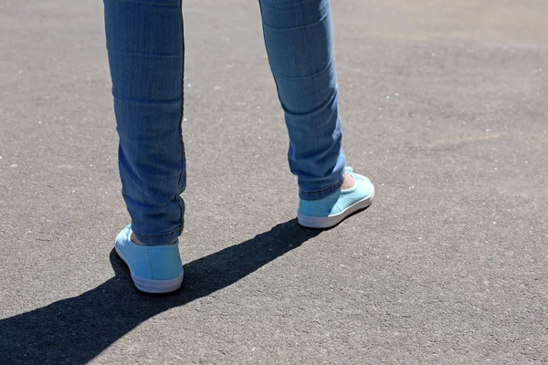 Female feet on gray — Stock Photo, Image