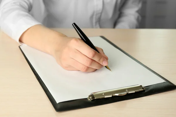 Businesswoman writing on document — Stock Photo, Image
