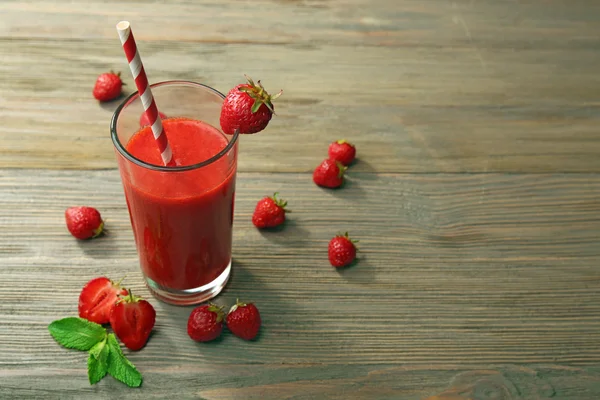 Glas strawberry smoothie met bessen op houten tafel close-up — Stockfoto
