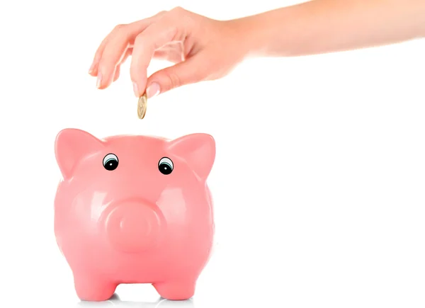 Hand inserting money into piggy bank isolated on white — Stock Photo, Image