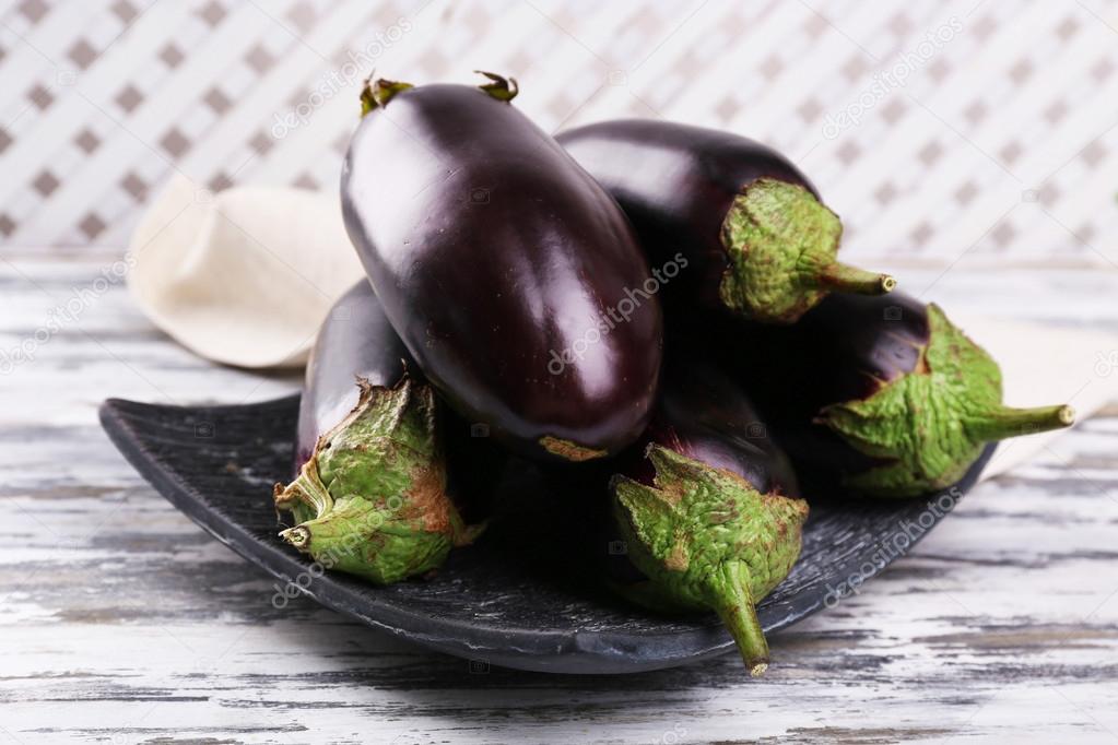Fresh eggplant on wooden table
