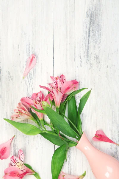 Beautiful alstroemeria in vase on wooden background — Stock Photo, Image